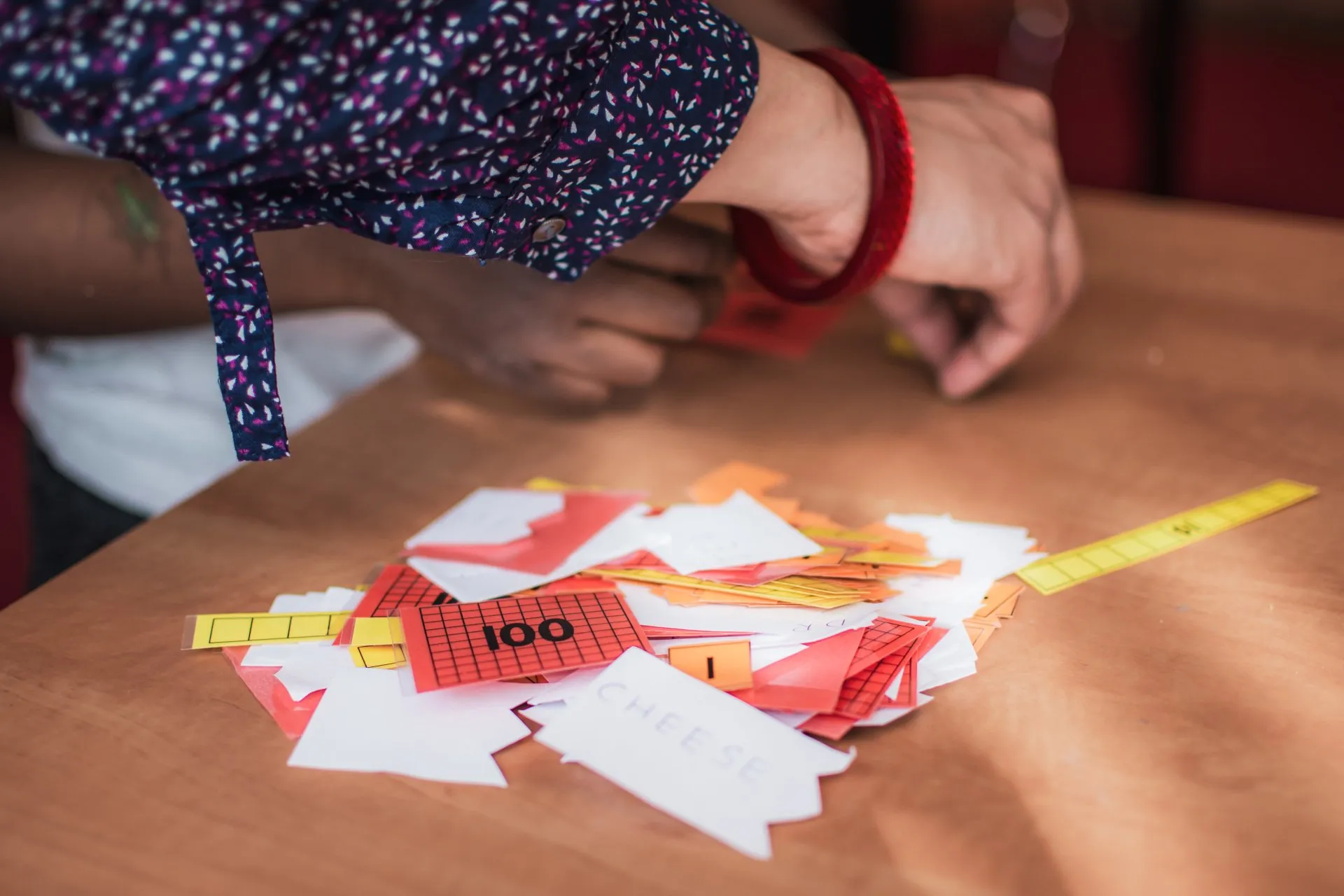 A child sorting colourful number and word cards on a table